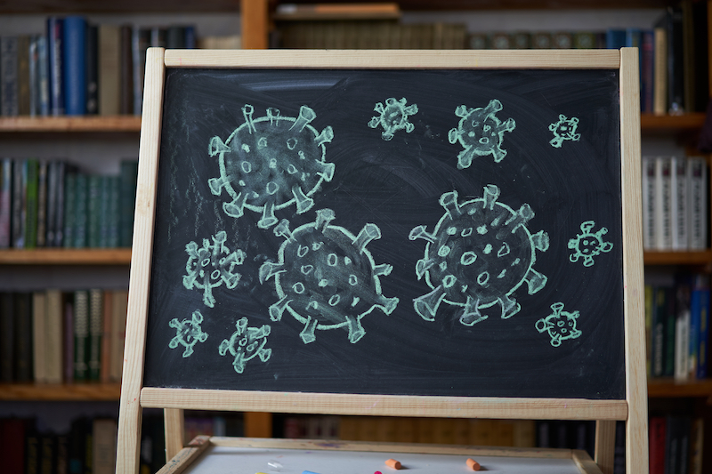 Outbreak Warning. written white chalk on blackboard in connection with epidemic of coronavirus worldwide.